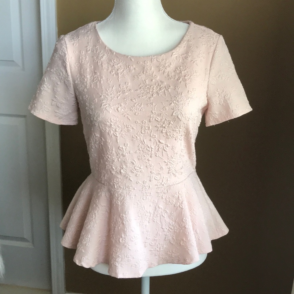 Stunning blush-colored patterned peplum top